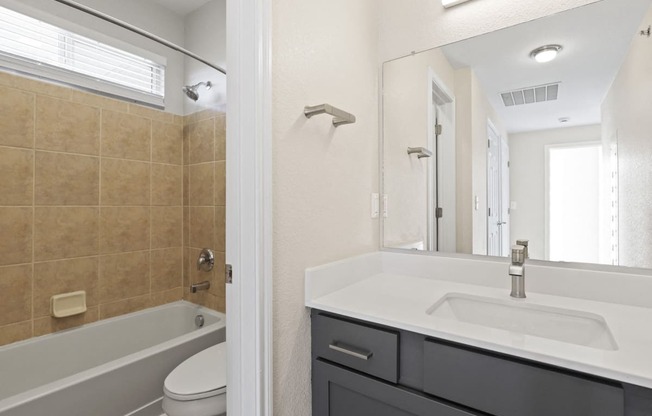 Brightly lit bathroom at Switchback on Platte Apartments, Littleton, Colorado