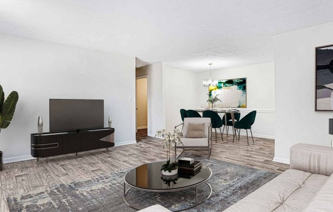 a living room and dining room with a couch and a table at Elea Apartments in Marietta, GA