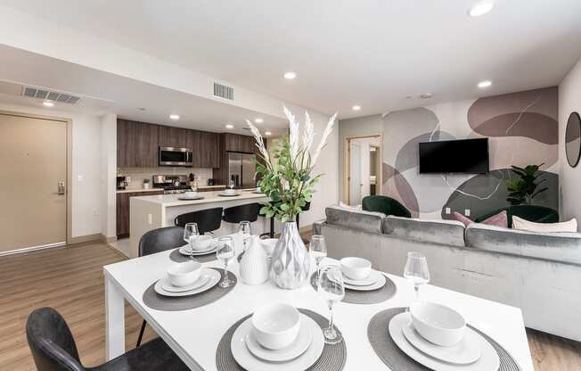 a dining room and living room with a table and chairs