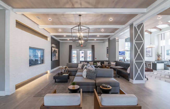 a large living room with couches and chairs and a chandelier