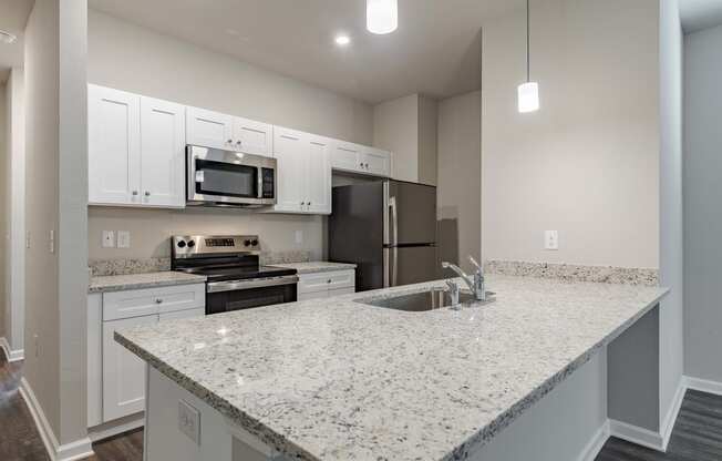 a kitchen with granite counter tops and a sink and a stove