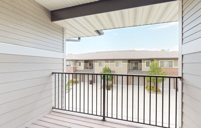 spacious balcony with rail and view of villas