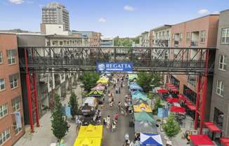 an aerial view of a city street with buildings and a bridge