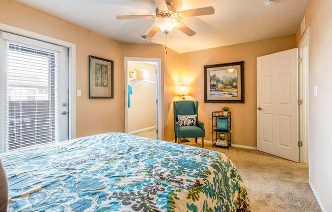 a bedroom with a large bed and a ceiling fan