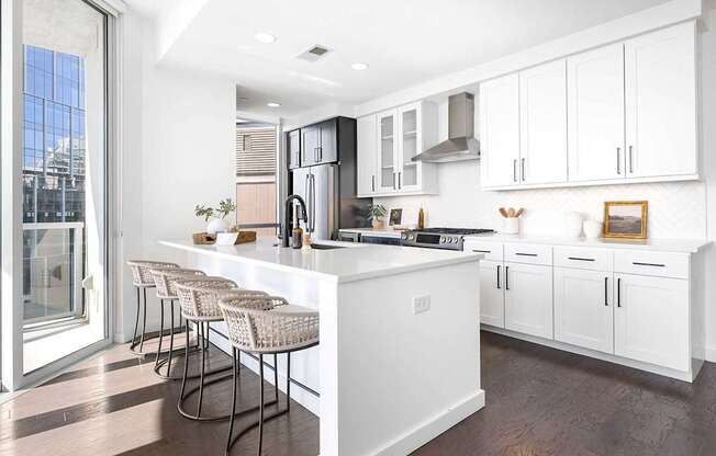 A modern kitchen with white cabinets and a large island.