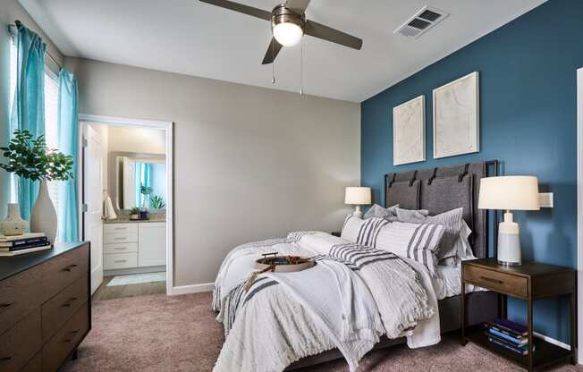 a bedroom with a large bed and a ceiling fan