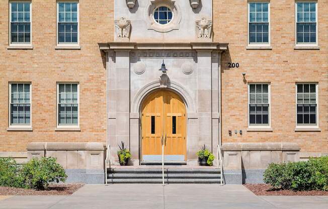 A large building with a yellow door and windows on the side.