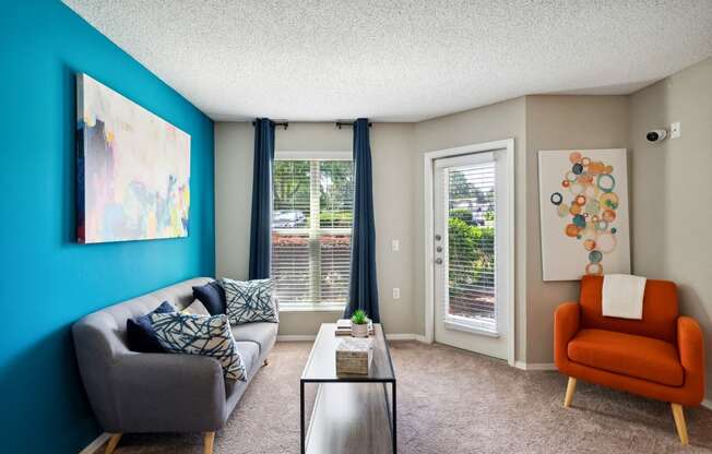 a living room with a blue wall and a couch and a table