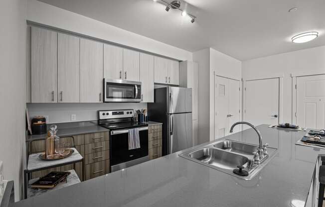 a kitchen with stainless steel appliances and a sink