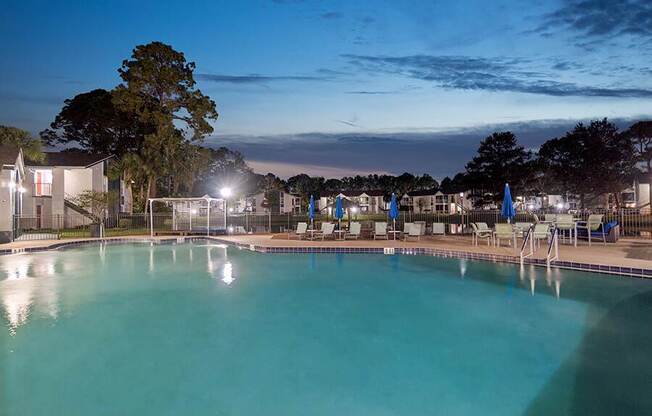 Community Swimming Pool with Pool Furniture at Vue at Baymeadows Apartments located in Jacksonville, FL.