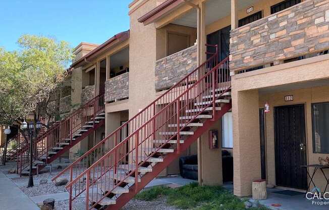 A building with a red staircase in front of it.