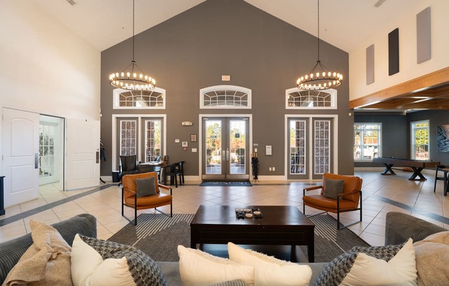 A large, open living room with a grey couch and a coffee table.