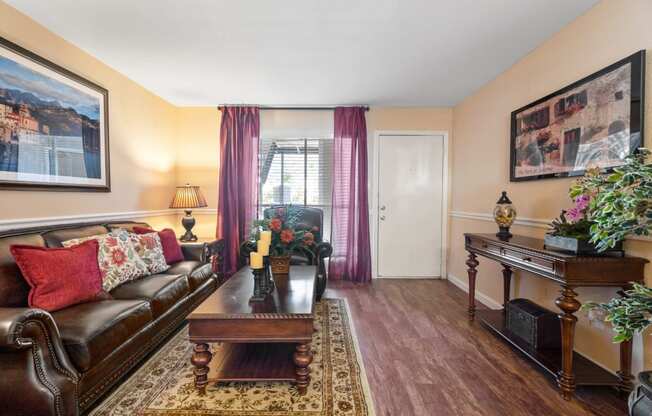 a living room with a leather couch and coffee table