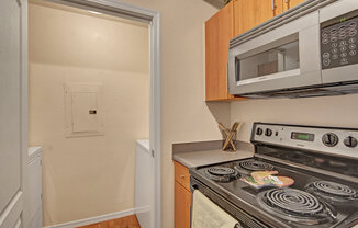 a kitchen with a stove and microwave
