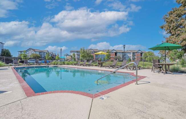 Pool area with seating and umbrellas at Ultris Island Park in Shreveport, LA