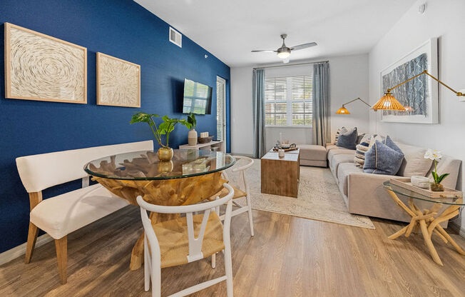 a living room with a blue accent wall and a table