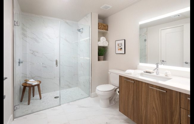 Spa-like bathrooms with rain shower head, custom shelves and stunning granite surrounds