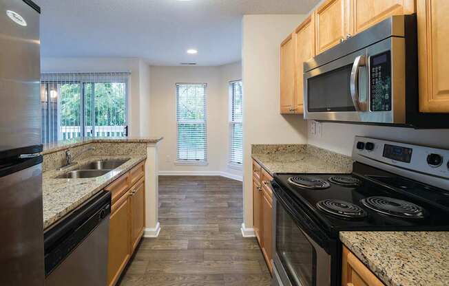 A kitchen with granite countertops and stainless steel appliances.