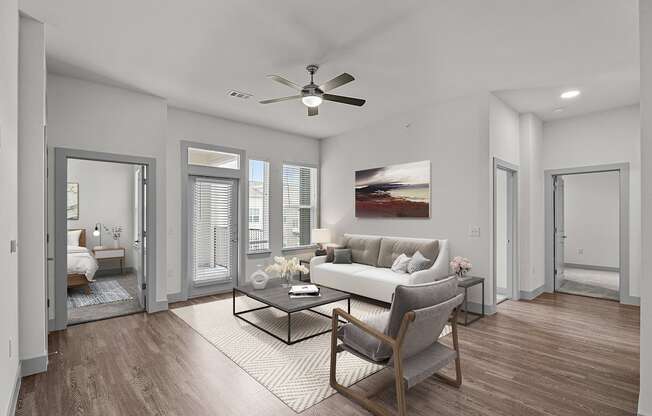 a living room with a couch and a ceiling fan