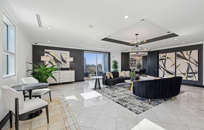 A spacious living room with a black and white color scheme.