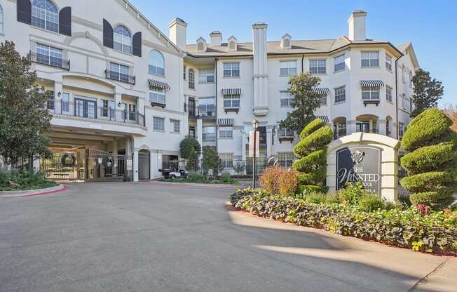 The entrance to a large white hotel with a sign that reads "The Westin".