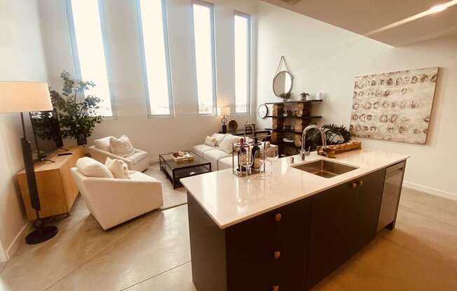 A modern kitchen with a white countertop and dark brown cabinets.