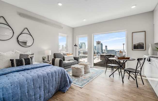 a bedroom with a large bed and a view of the city  at Oslo, Seattle, WA, 98102