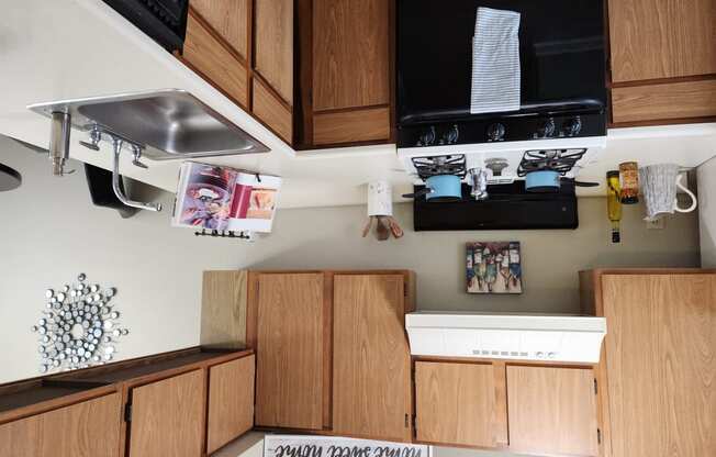 a kitchen with wooden cabinets and a sink and a microwave