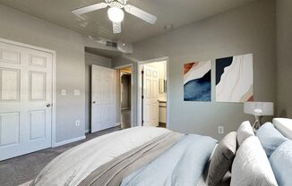 a bedroom with a bed and a ceiling fan