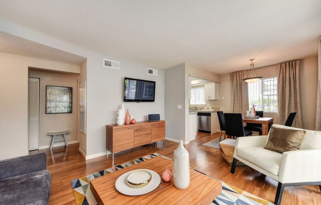 Living Room with Television with Wood Inspired Floor, White Sofa, 