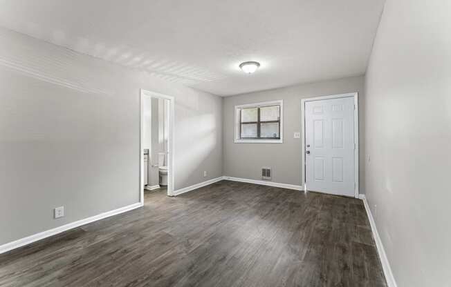 a bedroom with hardwood floors and grey walls  at Balfour 296, Georgia, 30047