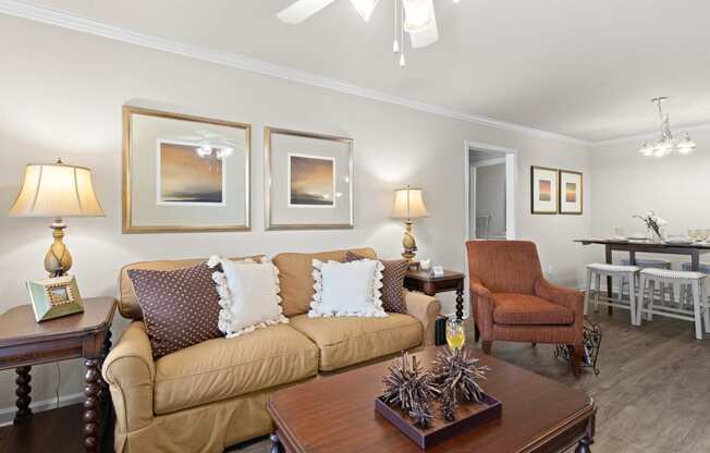 a living room filled with furniture and a ceiling fan