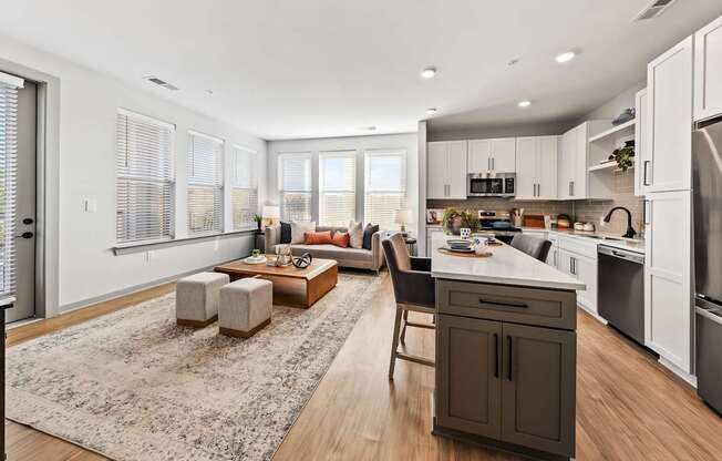 A modern kitchen with a dining area and a living room