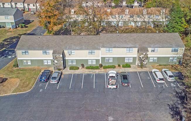 Element at 4411 Macon Apartments An aerial view of a parking lot with cars and apartment buildings.