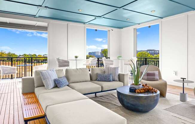 A modern living room with a large sofa set and a wooden bench.