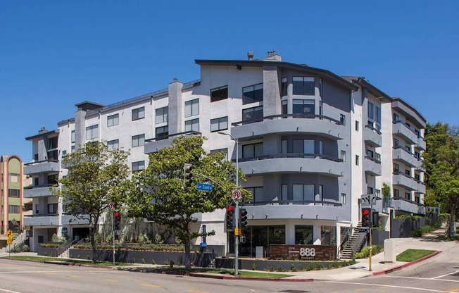 A modern apartment building with a clear blue sky above.