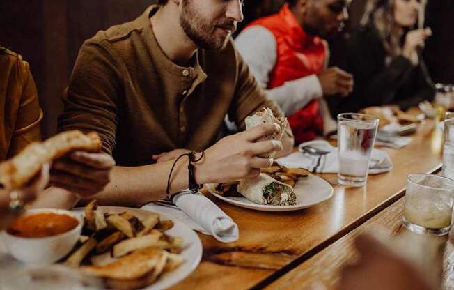 A group of people enjoying a meal together at a restaurant.