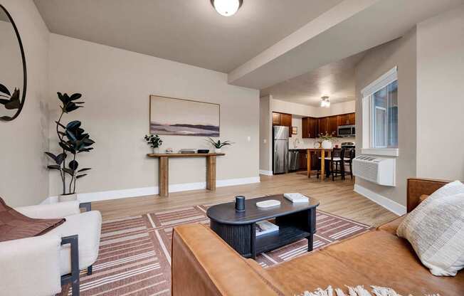 A living room with a couch, coffee table, and a painting on the wall.
