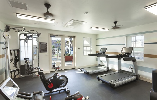 a gym with treadmills and other exercise equipment in a building