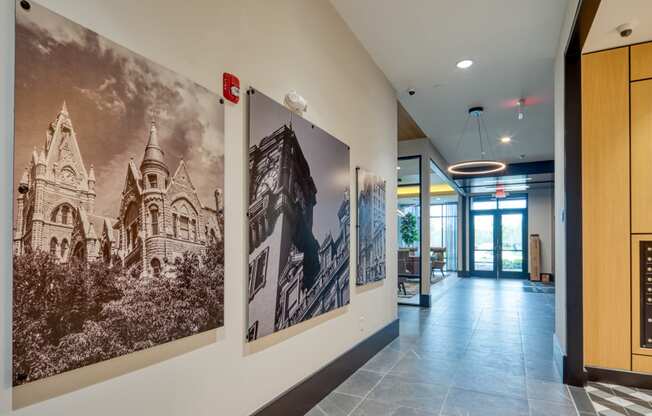 a hallway with large pictures on the wall and a lobby door at Aura Stonebridge, Richmond