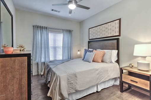 a bedroom with a bed and a ceiling fan