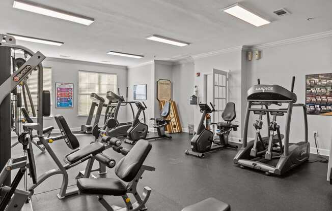 a gym with treadmills and other exercise equipment in a building