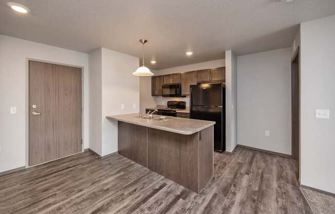 A kitchen with a wooden floor and a countertop.