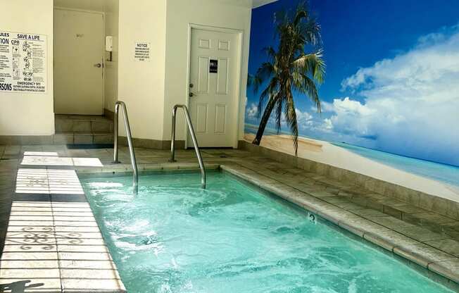 a large swimming pool in a building with a palm tree