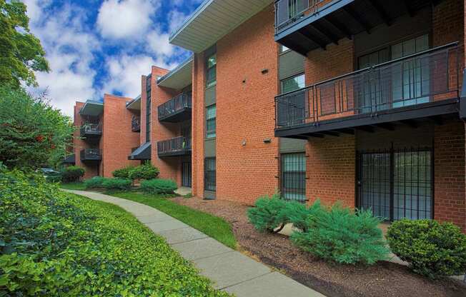 an apartment building with a sidewalk in front of it