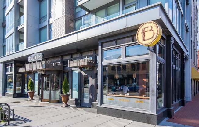 A storefront with a Bitcoin symbol on the sign.
