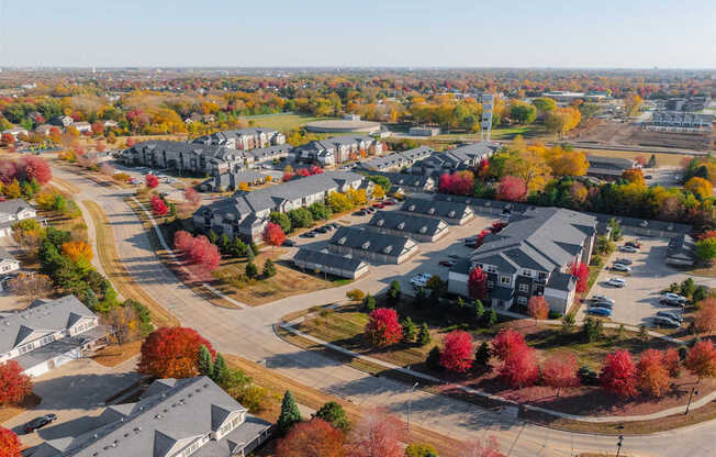 A suburban neighborhood with houses and trees in autumn colors.