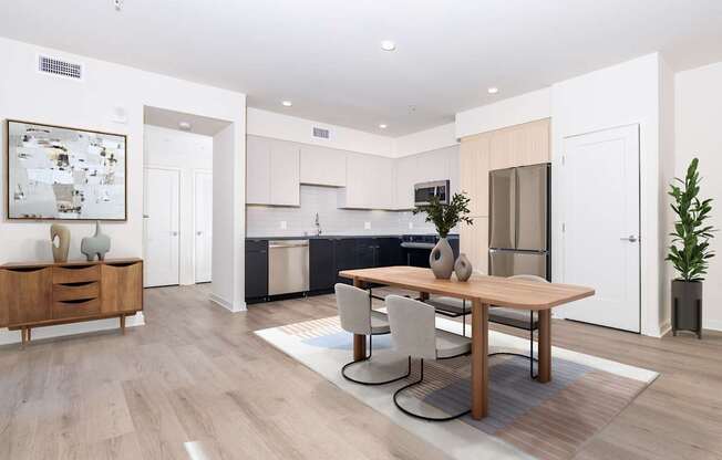 A modern kitchen with a dining table and chairs.