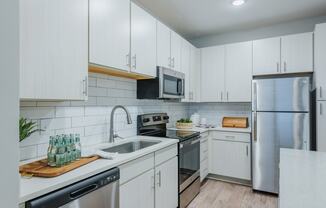 Modern kitchen with subway tile backsplash at Bon Haven Apartments in Spartanburg, SC