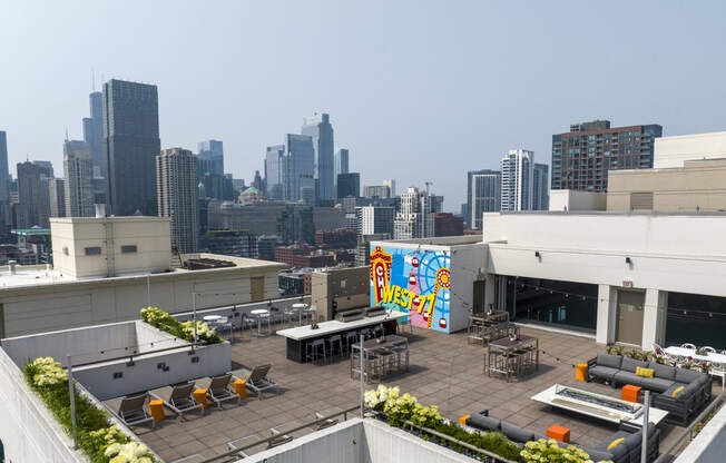 a rooftop patio with a view of the los angeles skyline